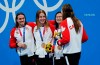 Canada's Kylie Masse, left to right, Sydney Pickrem, Maggie Mac Neil and Penny Oleksiak celebrate a bronze medal in the women's 4 x 100m medley relay final during the Tokyo Summer Olympic Games, in Tokyo on August 1, 2021. THE CANADIAN PRESS/Adrian Wyld
