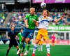 Seattle Sounders' Kelyn Rowe, left, goes up against San Jose Earthquakes' Florian Jungwirth in a battle for possession near the Seattle goal during the second half of an MLS soccer match Saturday, July 31, 2021, in Seattle.&nbsp;The Vancouver Whitecaps have announced a pair of deals as they look to bolster their squad. THE CANADIAN PRESS/AP-Dean Rutz/The Seattle Times via AP