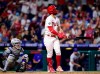 Philadelphia Phillies' Bryce Harper, right, watches his two-run home run off New York Mets' Yennsy Diaz during the eighth inning of a baseball game, Friday, Aug. 6, 2021, in Philadelphia. (AP Photo/Derik Hamilton)
