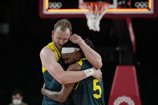Australia's Joe Ingles (7) and Patty Mills (5) react after beating Slovenia 107-93 during the men's bronze medal basketball game at the 2020 Summer Olympics, Saturday, Aug. 7, 2021, in Tokyo, Japan. (AP Photo/Eric Gay)