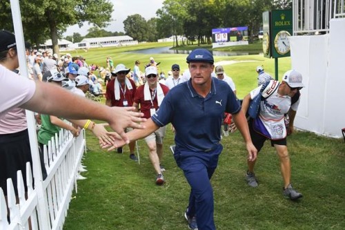 Bryson Dechambeau walks off the18th green after finishing the third round in the World Golf Championship-FedEx St. Jude Invitational tournament, Saturday, Aug. 7, 2021, in Memphis, Tenn. (AP Photo/John Amis)