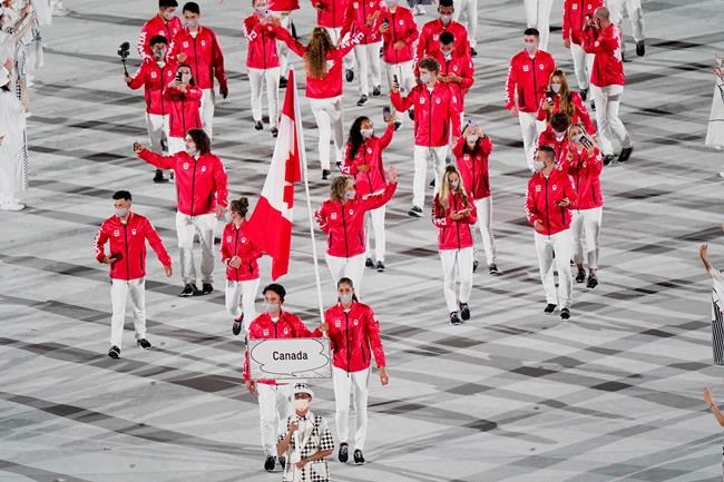 Team Canada flag-bearers Miranda Ayim and Nathan Hirayama carry the Canadian flag at the opening ceremonies during the Tokyo Olympics in Tokyo, Japan on Friday, July 23, 2021. Success and safety not mutually exclusive is the takeaway from Canada's performance in Tokyo's Olympics. THE CANADIAN PRESS/Adrian Wyld