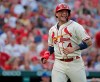 St. Louis Cardinals catcher Yadier Molina smiles while looking toward Kansas City Royals catcher Salvador Perez as Molina heads back to the dugout between the first and second innings of a baseball game Saturday, Aug. 7, 2021, in St. Louis. (AP Photo/Tom Gannam)