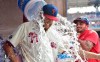 Philadelphia Phillies starting pitcher Zack Wheeler is doused with water in the dugout by teammates Zack Eflin, right and Aaron Nola, rear, after a victory against the New York Mets, Sunday, Aug. 8, 2021, in Philadelphia. The Phillies won 3-0. (AP Photo/Derik Hamilton)