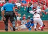 Kansas City Royals' Whit Merrifield (15) scores from third as St. Louis Cardinals catcher Andrew Knizner (7) fields a high hopping ball, as home plate umpire Angel Hernandez looks on, in the fifth inning of a baseball game, Sunday, Aug. 8, 2021, in St. Louis. (AP Photo/Tom Gannam)