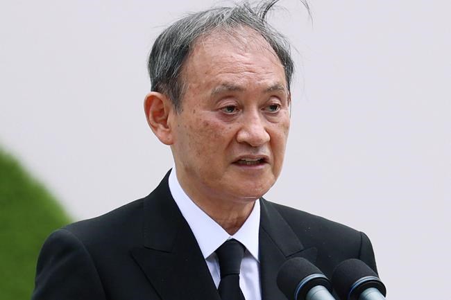 Japan's Prime Minister Yoshihide Suga delivers a speech during a ceremony at Nagasaki Peace Park in Nagasaki, southern Japan Monday, Aug. 9, 2021. The Japanese city of Nagasaki on Monday marked its 76th anniversary of the U.S. atomic bombing. (Kyodo News via AP)