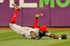 Cincinnati Reds' Aristides Aquino dives but cannot catch a double hit by Cleveland Indians' Amed Rosario in the eighth inning of a baseball game, Monday, Aug. 9, 2021, in Cleveland. (AP Photo/Tony Dejak)