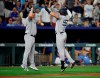 New York Yankees third base coach Phil Nevin, left, congratulates Luke Voit, right after hitting a home run during the ninth inning of a baseball game against the Kansas City Royals at Kauffman Stadium in Kansas City, Mo., Monday, Aug. 9, 2021. (AP Photo/Colin E. Braley)