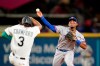 Texas Rangers second baseman Andy Ibanez, right, throws to first base after forcing out Seattle Mariners' J.P. Crawford (3) at second base during the fifth inning of a baseball game Tuesday, Aug. 10, 2021, in Seattle. Mitch Haniger was out at first on the double play. (AP Photo/Elaine Thompson)
