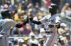 Miami Marlins' Lewis Brinson, right, reacts with teammate Isan Diaz after hitting a two-run home run during the first inning of a baseball game against the San Diego Padres, Wednesday, Aug. 11, 2021, in San Diego. (AP Photo/Gregory Bull)