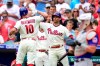 Philadelphia Phillies' J.T. Realmuto (10) is congratulated by Brad Miller after Realmuto hit a solo home run off New York Mets starting pitcher Taijuan Walker during the first inning of a baseball game, Sunday, Aug. 8, 2021, in Philadelphia. (AP Photo/Derik Hamilton)