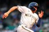 Milwaukee Brewers' Kolten Wong heads home to score on a Christian Yelich single during the first inning of the team's baseball game against the Chicago Cubs in Chicago, Wednesday, Aug. 11, 2021. (AP Photo/Nam Y. Huh)