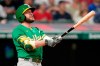 Oakland Athletics' Jed Lowrie watches his three-run home run during the eighth inning of the team's baseball game against the Cleveland Indians, Wednesday, Aug. 11, 2021, in Cleveland. (AP Photo/Tony Dejak)