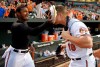 FILE - Baltimore Orioles' Adam Jones, left, throws a pie in the face of teammate Chris Davis after the Orioles' baseball game against the Houston Astros in Baltimore, in this Wednesday, May 27, 2015, file photo. Davis hit two home runs, including a go-ahead solo shot in the eighth inning, as the Orioles won 5-4. Slugger Chris Davis announced his retirement Thursday, Aug. 12, 2021, ending a career in which he became one of baseball's most prodigious home run hitters before his production declined amid injury problems during his final seasons with the Baltimore Orioles.(AP Photo/Nick Wass)