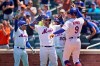 New York Mets' Marcus Stroman, left, and Jonathan Villar, center, greet Brandon Nimmo (9) after he hit a three-run homer during the second inning of a baseball game against the Washington Nationals at Citi Field, Thursday, Aug. 12, 2021, in New York. (AP Photo/Seth Wenig)