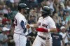 Boston Red Sox's Enrique Hernandez, right is congratulated by on deck batter J.D. Martinez after scoring on a hit by Rafael Devers during the fourth inning of a baseball game against the Tampa Bay Rays at Fenway Park, Thursday, Aug. 12, 2021, in Boston. (AP Photo/Mary Schwalm)