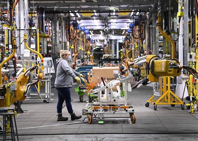 GM workers use human assistance automation to weld vehicle doors at the General Motors assembly plant during the COVID-19 pandemic in Oshawa, Ont., Friday, March 19, 2021. Canadian auto parts suppliers say the chip shortage that has created havoc in the industry and shortages at dealerships has been worse than expected and could continue to prove forecasts wrong. THE CANADIAN PRESS/Nathan Denette