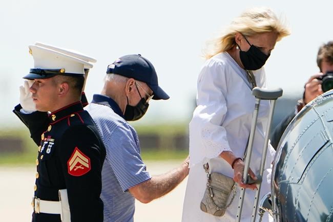 President Joe Biden helps first lady Jill Biden as they board Marine One to depart Delaware Air National Guard Base in New Castle, Del., Friday, Aug. 13, 2021. (AP Photo/Manuel Balce Ceneta)