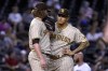 San Diego Padres third baseman Manny Machado, right, talks to relief pitcher Pierce Johnson during the seventh inning of the team's baseball game against the Arizona Diamondbacks on Friday, Aug 13, 2021, in Phoenix. (AP Photo/Darryl Webb)