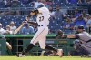 Pittsburgh Pirates' Kevin Newman (27) hits a double in front of Milwaukee Brewers catcher Manny Pina to drive in two runs in the fifth inning of the first game of a split doubleheader baseball game, Saturday, Aug. 14, 2021, in Pittsburgh. (AP Photo/Keith Srakocic)