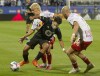 CF Montreal Joaquin Torres, centre, battles his way through New York Red Bulls' John Tolkin and Andrew Gutman during MLS soccer action in Montreal on Saturday August 14, 2021THE CANADIAN PRESS/Peter McCabe