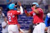 Miami Marlins' Jazz Chisholm Jr. (2) greets Jesus Aguilar after they scored on a two-run home run hit by Aguilar during the eighth inning of a baseball game against the Chicago Cubs, Sunday, Aug. 15, 2021, in Miami. (AP Photo/Lynne Sladky)