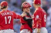 Cincinnati Reds shortstop Kyle Farmer (17), catcher Tucker Barnhart, center, and first baseman Joey Votto (19) celebrate after they defeated the Philadelphia Phillies in a baseball game, Sunday, Aug. 15, 2021, in Philadelphia. (AP Photo/Laurence Kesterson)