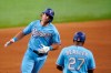 Texas Rangers' DJ Peters, left, and third base coach Tony Beasley (27) celebrate Peters' two-run home run in the fifth inning of a baseball game against the Oakland Athletics in Arlington, Texas, Sunday, Aug. 15, 2021. (AP Photo/Tony Gutierrez)