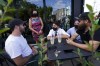 Liberal Party Leader Justin Trudeau is joined by Liberal candidates Ramez Ayoub, back right, and Linda Lapointe, back left, as he talks to people as he makes a whistle-stop at a coffee shop in Blainville, Que., Sunday, Aug. 15, 2021, on the first day of the election campaign. THE CANADIAN PRESS/Sean Kilpatrick