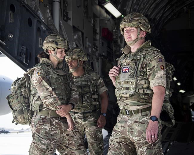 In this photo provided by the Ministry of Defence on Sunday, Aug. 15, 2021, members of the 16 Air Assault Brigade arrive in Kabul as part of a 600-strong UK-force sent to assist with Operation PITTING to rescue British nationals in Afghanistan amidst the worsening security situation there. (Leading Hand Ben Shread/Ministry of Defence via AP)
