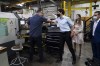 Liberal Leader Justin Trudeau gives an employee an elbow bump as he and Liberal candidate for the riding of Longueuil-Saint-Hubert, Florence Gagnon, are given a tour of ETI Converting Equipment's facility by ETI President Maxime Bayzelon in Longueuil, Que. on Monday, Aug. 16, 2021. ETI's website says they are a globally innovative manufacturer of in-line coating and printing equipment dedicated to the label printing industry. THE CANADIAN PRESS/Sean Kilpatrick