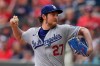 FILE - In this June 6, 2021, file photo, Los Angeles Dodgers starting pitcher Trevor Bauer delivers in the first inning of a baseball game against the Atlanta Braves in Atlanta. An attorney for Bauer told a judge that the Dodgers pitcher had every reason to believe that a woman wanted the rough treatment he gave her in two sexual encounters that led to her seeking a five-year restraining order against him. Lawyer Shawn Holley made the argument at a hearing Monday, Aug. 16, 2021, in Los Angeles. (AP Photo/Brynn Anderson, File)