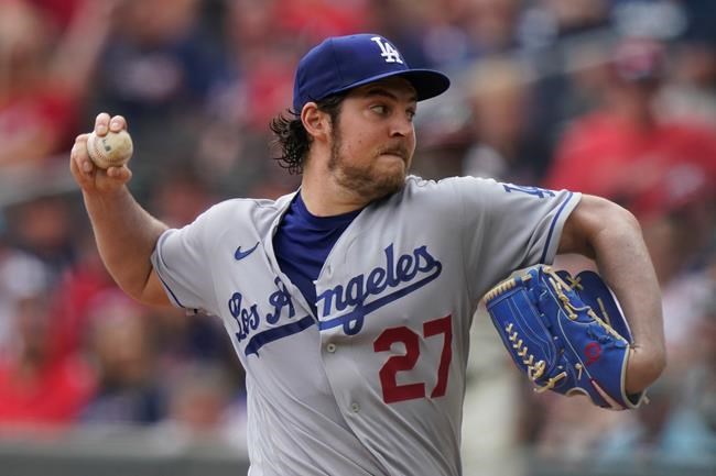 FILE - In this June 6, 2021, file photo, Los Angeles Dodgers starting pitcher Trevor Bauer delivers in the first inning of a baseball game against the Atlanta Braves in Atlanta. An attorney for Bauer told a judge that the Dodgers pitcher had every reason to believe that a woman wanted the rough treatment he gave her in two sexual encounters that led to her seeking a five-year restraining order against him. Lawyer Shawn Holley made the argument at a hearing Monday, Aug. 16, 2021, in Los Angeles. (AP Photo/Brynn Anderson, File)