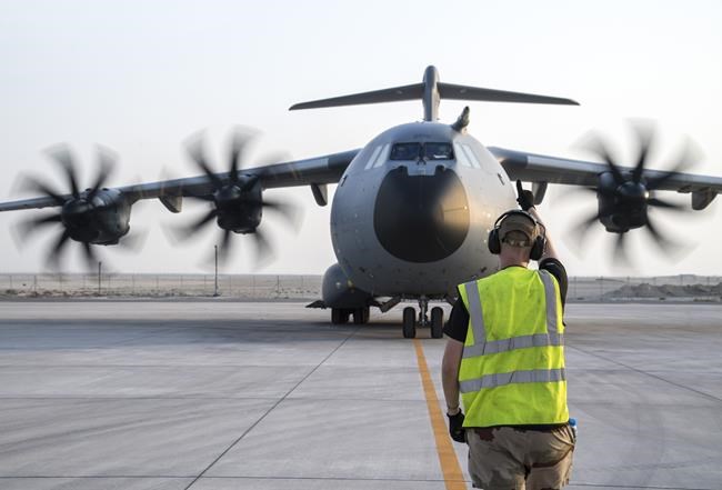 In this photo provided Tuesday Aug.17, 2021 by the French Defense Ministry, a French soldier directs a military Airbus A400M after landing in Abu Dhabi, Monday, Aug.16, 2021. France is relocating its embassy in Kabul to the airport to evacuate all citizens still in Afghanistan, initially transferring them to Abu Dhabi. Evacuations have been in progress for weeks and a charter flight put in place by France in mid-July. (Etat-Major des Armees via AP)