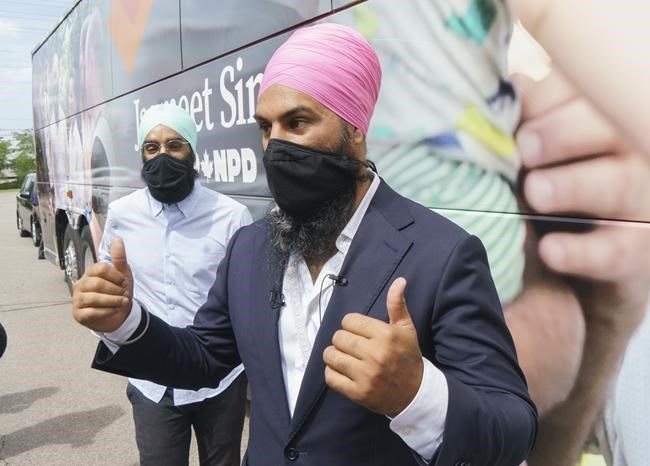 NDP Leader Jagmeet Singh walks back to his campaign bus with his younger brother Gurratan in Brampton, Ont., on Monday, August 16, 2021. THE CANADIAN PRESS/Paul Chiasson