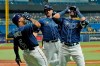 Tampa Bay Rays' Nelson Cruz, right, celebrates with Wander Franco, left, and Kevin Kiermaier after Cruz hit a three-run home run off Baltimore Orioles starting pitcher John Means during the fifth inning of a baseball game Tuesday, Aug. 17, 2021, in St. Petersburg, Fla. (AP Photo/Chris O'Meara)