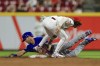 Chicago Cubs' Andrew Romine, back, is tagged out by Cincinnati Reds' Jonathan India (6) at second base during the ninth inning of a baseball game in Cincinnati, Tuesday, Aug. 17, 2021. Romine was caught stealing. The Cubs won 2-1. (AP Photo/Aaron Doster)