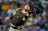 San Diego Padres catcher Victor Caratini catches a pop foul by Colorado Rockies' Elias Diaz during the seventh inning of a baseball game Tuesday, Aug. 17, 2021, in Denver. (AP Photo/David Zalubowski)