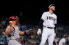 Arizona Diamondbacks' Drew Ellis, right, reacts to being called out on strikes as Philadelphia Phillies catcher J.T. Realmuto, left, holds the ball during the fifth inning of a baseball game Tuesday, Aug. 17, 2021, in Phoenix. (AP Photo/Ross D. Franklin)