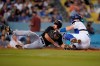 Pittsburgh Pirates' Bryan Reynolds, left, scores past Los Angeles Dodgers catcher Will Smith on a ground ball by Jacob Stallings during the fourth inning of a baseball game Tuesday, Aug. 17, 2021, in Los Angeles. (AP Photo/Marcio Jose Sanchez)