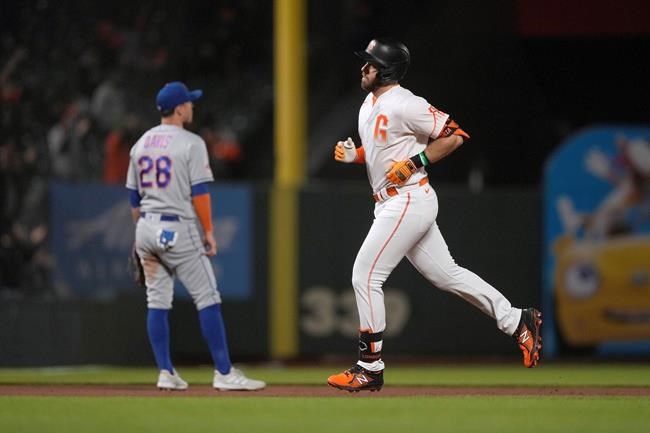 San Francisco Giants' Evan Longoria runs the bases near New York Mets third baseman J.D. Davis (28) after hitting a solo home run during the seventh inning of a baseball game Tuesday, Aug. 17, 2021, in San Francisco. (AP Photo/Tony Avelar)