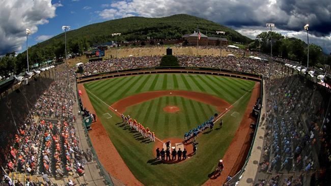 FILE - River Ridge, Louisiana, lines the third baseline and Curacao lines the first baseline during team introductions before the Little League World Series Championship game at Lamade Stadium in South Williamsport, Pa., Sunday, Aug. 25, 2019. The Little League World Series is back. There won’t be international teams or 22,000 fans in the stands for the championship, but the tournament in South Williamsport, Pennsylvania, is set to start on Thursday, Aug. 19, 2021. (AP Photo/Gene J. Puskar)