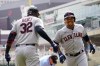 Cleveland Indians' Jose Ramirez, right, scores on his solo home run off Minnesota Twins pitcher Lewis Thorpe in the first inning of a baseball game, Wednesday, Aug. 18, 2021, in Minneapolis. (AP Photo/Jim Mone)