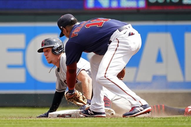 Cleveland Indians' Myles Straw, left, beats the tag by Minnesota Twins second baseman Jorge Polanco to steal second base in the fourth inning of a baseball game, Wednesday, Aug. 18, 2021, in Minneapolis. (AP Photo/Jim Mone)