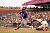 New York Mets' Michael Conforto, left, hits an RBI-double in front of San Francisco Giants catcher Buster Posey during the eleventh inning of a baseball game in San Francisco, Wednesday, Aug. 18, 2021. (AP Photo/Jeff Chiu)