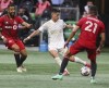 Atlanta United forward Luiz Araujo, works against Toronto FC midfielder Jonathan Osorio (21) during the first half of an MLS soccer match on Wednesday, Aug. 18, 2021, in Atlanta. (Curtis Compton/Atlanta Journal-Constitution via AP)