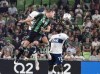 Austin FC's Tomas Pochettino, front, heads the ball away from Vancouver Whitecaps forward Cristian Dajome, right, and defender Jake Nerwinski, back, during the first half of an MLS soccer match Wednesday, Aug. 18, 2021, in Austin, Texas. (AP Photo/Michael Thomas)