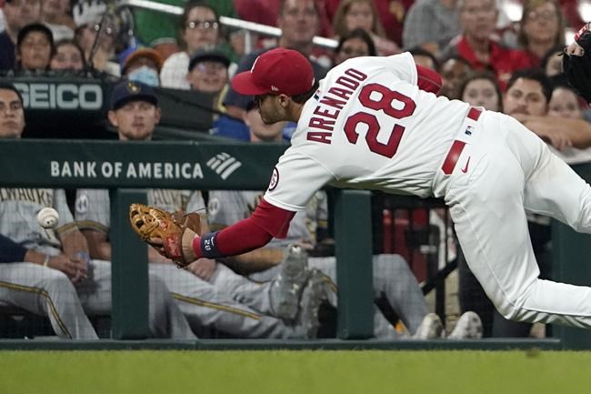 St. Louis Cardinals third baseman Nolan Arenado dives but is unable to catch a foul ball by Milwaukee Brewers' Omar Narvaez during the sixth inning of a baseball game Wednesday, Aug. 18, 2021, in St. Louis. (AP Photo/Jeff Roberson)