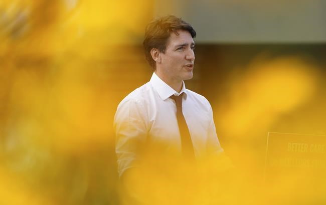 Liberal Leader Justin Trudeau comforts Darryl Woodburn as he makes a campaign stop at a long term care home in Victoria, B.C., Thursday, Aug. 19, 2021. Woodburn's wife recently passed away. They had been married for 67 years. THE CANADIAN PRESS/Sean Kilpatrick
