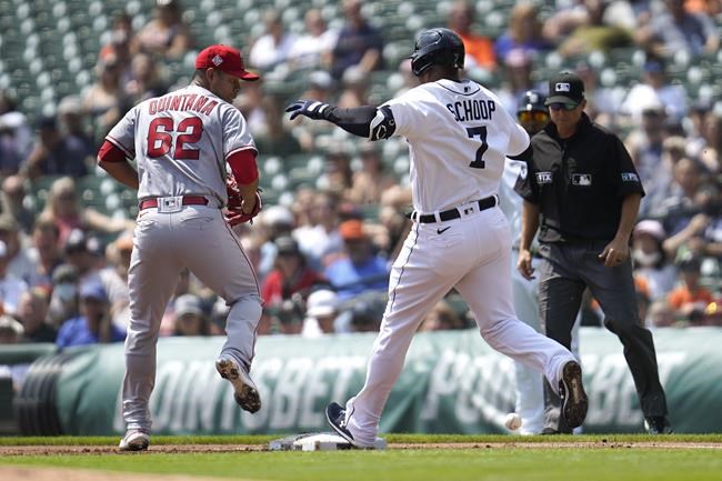 Detroit Tigers' Jonathan Schoop crosses first base safely as Los Angeles Angels pitcher Jose Quintana can't handle the throw while covering the base in the first inning of a baseball game in Detroit, Thursday, Aug. 19, 2021. (AP Photo/Paul Sancya)